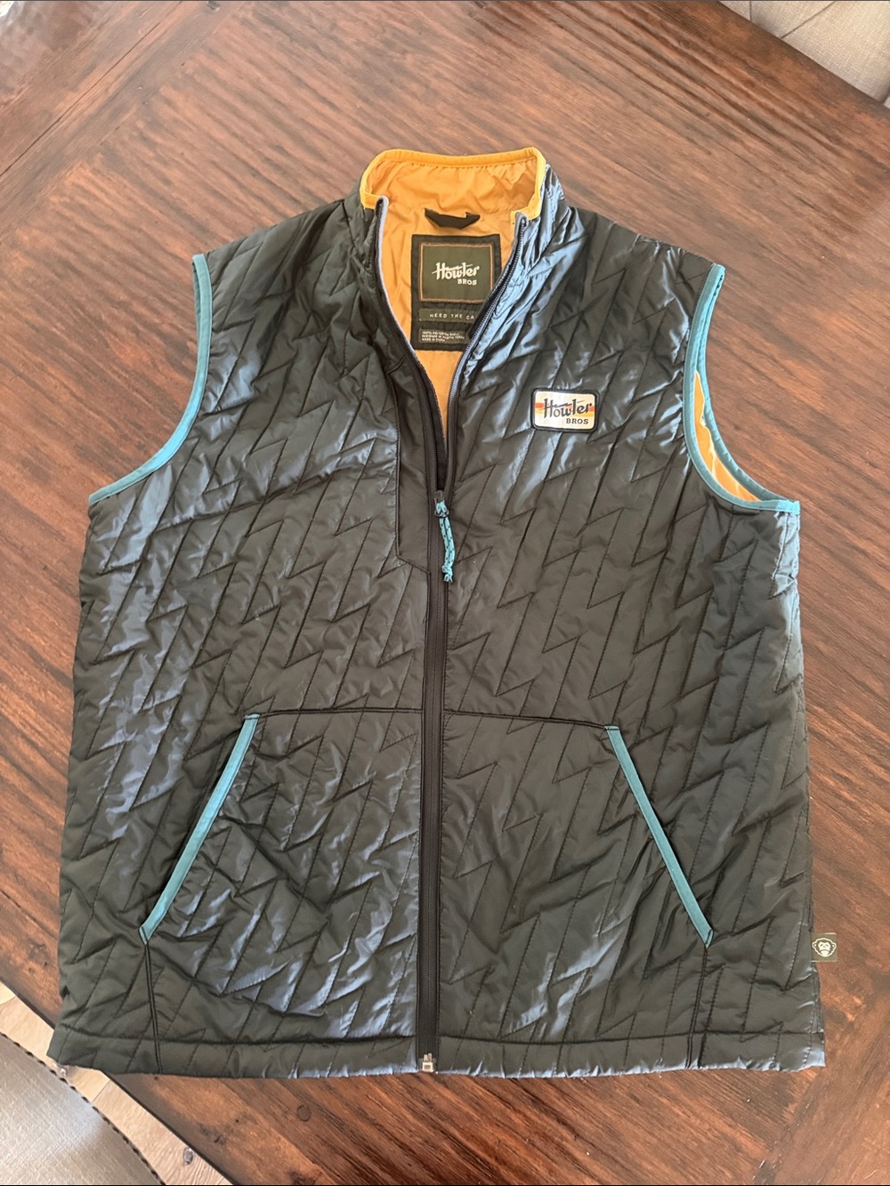 Howler Brothers Black Quilted Vest with Teal Trim and Yellow Lining